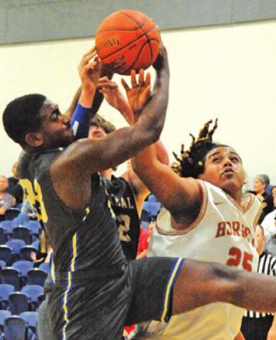 DEE MORRIS OF Caldwell fights for the ball against Rockdale in the Hornets’ win.
