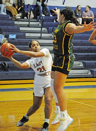 AVELYNN O’RILEY looks to pass the ball during the Caldwell-Lexington game at the Snook Lady Jays Basketball Tournament.