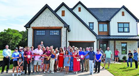 A RIBBON CUTTING IS held for The Reserve Subdivision in Somerville off Thornberry Drive on Wednesday, July 2. One home is completed, and another is under construction. Developers are planning a total of 145 homes in three to five years. They are beginning with the first of three planned phases, and city-required infrastructure for phase one is now complete.