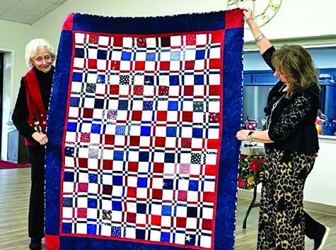 MEMBERS OF THE CREATIVE MEMORIES Quilt Guild sewed Quilts of Valor for veterans in the area, one block at a time, Sara Byman, left, quilted this beautiful Disappearing Four Patch quilt to be awarded to a veteran, with Bekki Campise, right, assisting in holding the quilt. The Creative Memories Quilt Guild meets at the Methodist Church on Fox Street in Caldwell, usually on the fourth Wednesday of the month. Photo courtesy of Barbara Behler