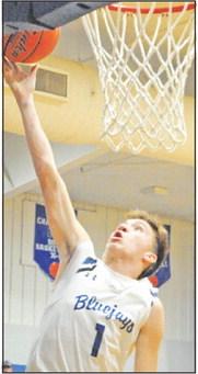 BRETT WITHEM OF the Snook Bluejays takes a shot in the home game against Mumford. -- Tribune photo by Denise Squier