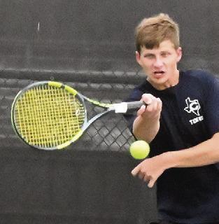 BRYCE BARR keeps the ball alive during a boys doubles match at the Caldwell-Franklin team tennis match last week. Tribune photo by Denise Squier