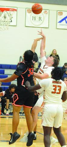 MATTHEW BAASEN fights for the ball. Also pictured is Jegorean Hewitt. Tribune photo by Denise Squier