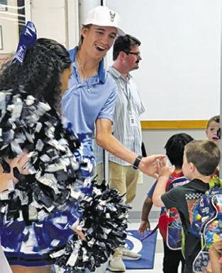 SNOOK’S BRETT Withem greets students during a sendoff prior to his appearance at the state golf tournament in Austin.