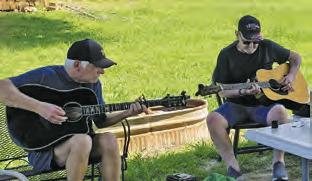 AREA MUSICIANS ENJOY the Sunday Song Circle on Sunday, May 19, outside Front Street Burgers in downtown Chriesman.