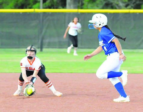 SOMERVILLE SHORTSTOP AUBREY Flencher fields a ground ball while Snook’s Ashley Quevedo runs from second to third.