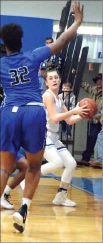 NATALIE VACHA looks to pass around a Navasota defender during the Snook-Navasota game on Friday in Snook. Snook won the game 40-19. -- Tribune photo by Denise Hornaday