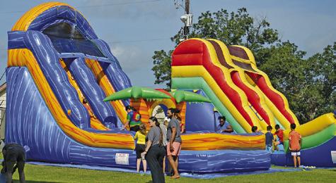 AREA CHILDREN ENJOYED WATERSLIDES and other fun activities at the Harrie P. Woodson Memorial Library’s end of summer water party at J.E. Hejl Park at Davidson Creek. Tribune photo by Kimberly Hutcheson