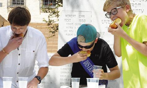 THE GUYS EAT kolaches as fast as they can during the eating contest to be named the winner. Tribune photo by Denise Squier