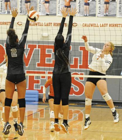 CALDWELL’S CAITLYN FAUST gets one of her five kills against Manor New Tech last Friday. -- Tribune photo by Denise Squier