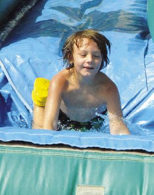 WATER SLIDES were part of the fun at last Thursday’s Special Event Thursday, hosted by the Harrie P. Woodson Memorial Library. Tribune photo by Denise Squier
