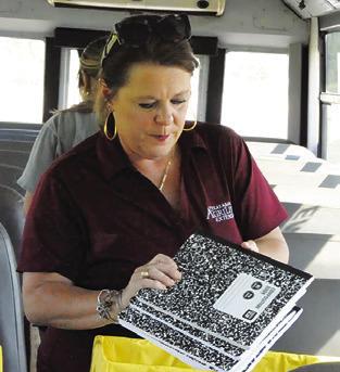 HOLLY NARRO with the Texas A&amp;M AgriLife Extension Office places composition books in a box during Monday’s “Stuff the Bus” event. Tribune photo by Denise Squier