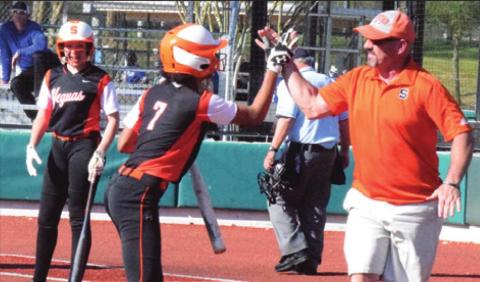 SOMERVILLE’S RA’MAYA Carter celebrates with head coach Cal Neatherlin after Carter hits an in-the-park home run against Navasota at the Franklin Tournament. -- Tribune photo by Denise Hornaday