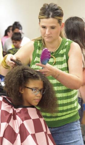 THE BACK TO SCHOOL Blast event not only gave out school supplies to area students, they were able to get free hair cuts and hair styles. Tribune photo by Denise Squier