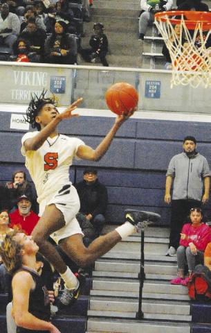 BRANDYN CARTER LUNGES for this shot against Iola. Somerville won 57-53. -- Tribune photo by Denise Squier