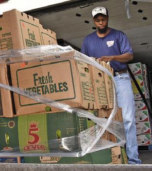 MARQUIS PRATT OF the Brazos Valley Food Bank delivers food on Saturday morning, July 12, to the food pantry at In God’s Hands Ministry at Cade Lake. The ministry helps local residents.