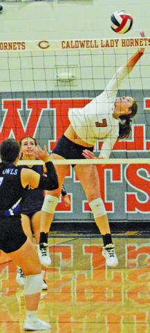 LYDIA GIESE stretches to keep the ball in play, hitting it over the net during Caldwell’s win over Anderson-Shiro on Friday. Tribune photo by Kimberly Hutcheson