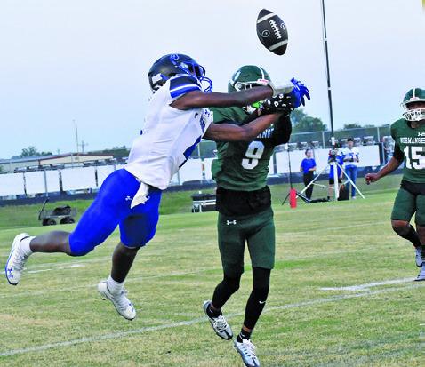 SNOOK’S JOHN CARR and a Normangee defender go for the ball in last Friday night’s game in Normagnee. Tribune photo by Roy Sanders