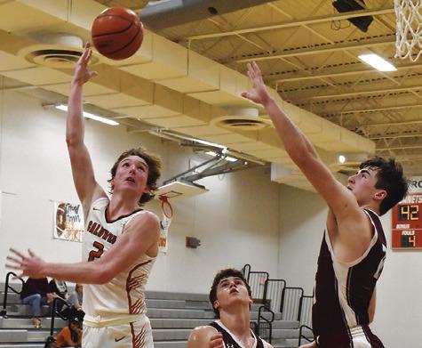 RYAN SEE ARCHES for this shot against Troy last Friday. The Hornets lost 61-42 and fell to 10-11 for the year. Tribune photo by Roy Sanders