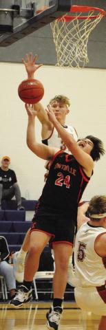 TRAVIS CUNNINGHAM of Caldwell reaches high to block this Smithville shot. -- Tribune photo by Denise Squier
