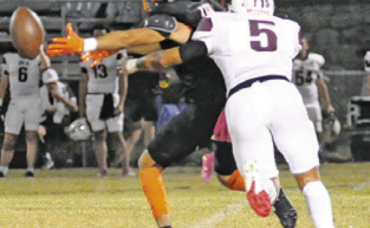 KYLE BROOKS of Somerville reaches for the ball as this Iola defender moves in. Tribune photo by Denise Squier