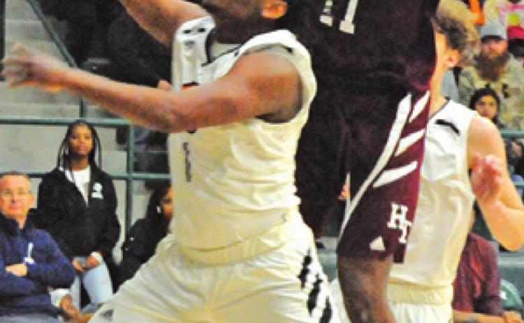 ARVIS BURNS ATTEMPTS to get a shot off while Hearne’s Jabari Dunn defends during last Friday’s area playoff game at Rudder High School. -- Tribune photo by Denise Squier