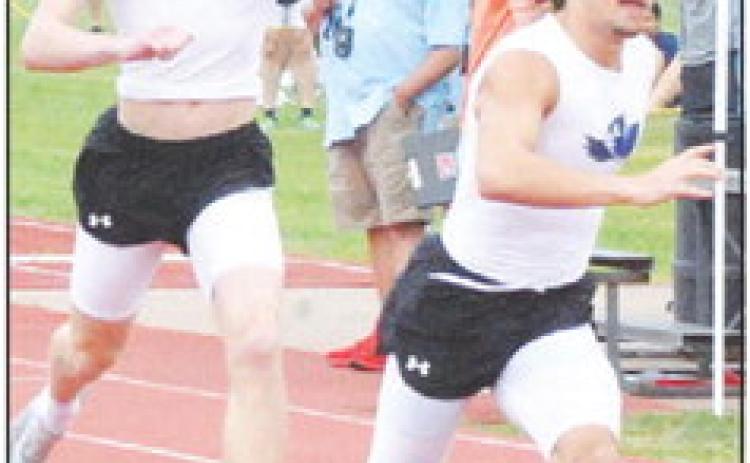 A SNOOK RELAY TEAM passes tbe baton cleanly during last week’s Koppers Relays.