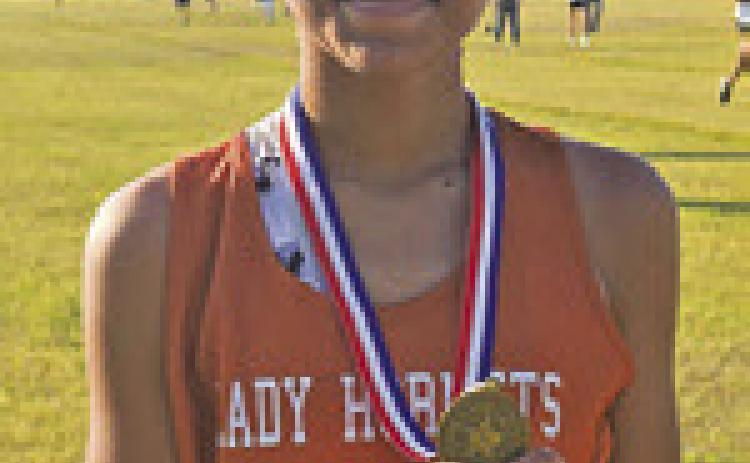 AJRIANA SIMS won the girls race at the district junior high cross country meet last Tuesday.