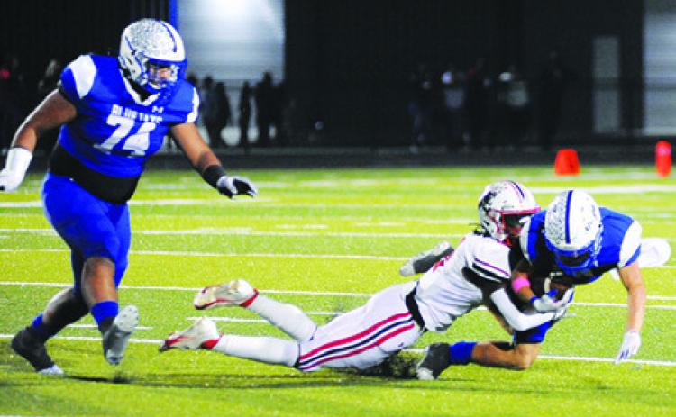 LANCE LARA CARRIES the ball for Snook against Burton. Also pictured is Snook’s Gabe Martinez. See story inside. -- Tribune photo by Denise Squier