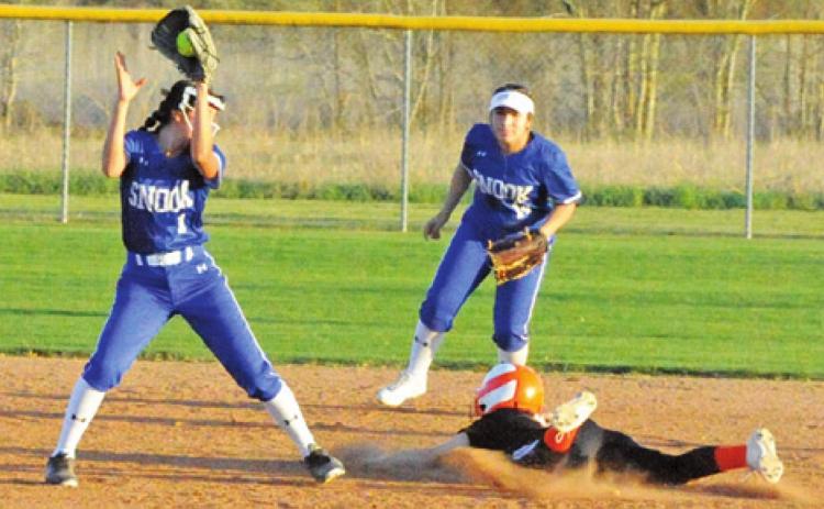 SOMERVILLE’S CAYLA BALANGA slides safely into second base while Snook’s Paola Arredondo sets to attempt a tag. Also pictured is Snook’s Nadia Garcia. -- Tribune photo by Denise Squier
