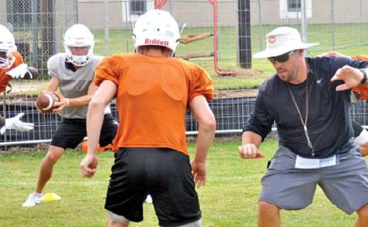 NEW CALDWELL HEAD COACH Matt Langley instructs his players during this Friday workout at the high school. The Hornets will scrimmage Waco Robinson this Friday, and they open their season at home on Aug. 30 against Edna. -- Tribune photo by Roy Sanders