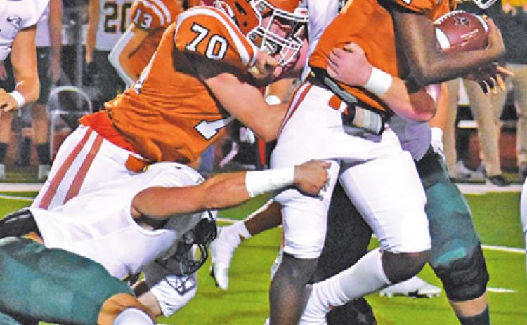 CALDWELL’S JAMAR HEWITT tries to gain more yards while in the grasp of a Bumblebee defender during Friday night’s game. Also pictured is Justin Balcar for Caldwell. -- Tribune photo by Roy Sanders
