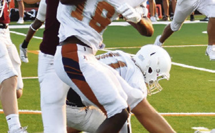 THE HORNETS Dejuan Mathis carries the ball against Troy. Caldwell opens the season this Friday at Crockett.