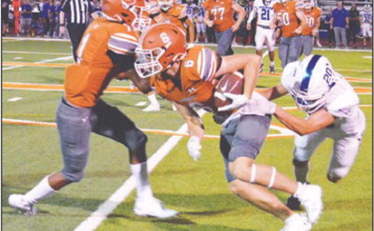 JAMIN WHITE OF Caldwell fights past this Robinson defender in the Hornets 28-0 home loss last Friday. -- Tribune photo by Roy Sanders
