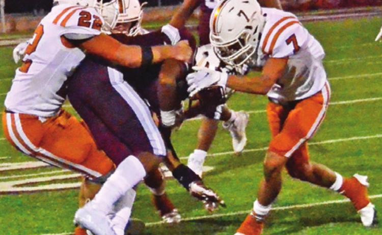 CALDWELL’S LARAMIE PIEPER and Zach Heaton make this tackle last Friday against Cameron. -- Tribune photo by Roy Sanders