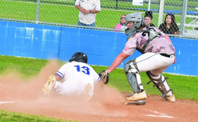 JACOB CASTANEDA slides into home for a score for Snook in an 11-1 win over Mumford. -- Tribune photo by Roy Sanders
