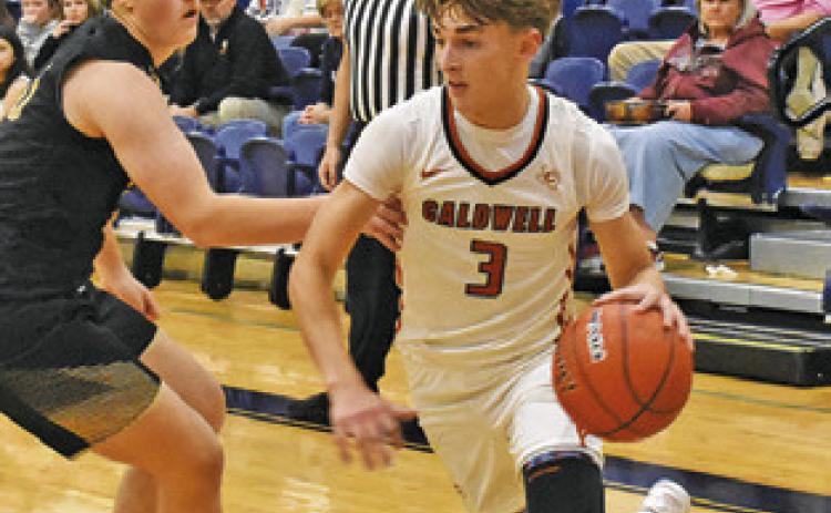 DYLAN CHAPMAN of Caldwell dribbles the ball past this Giddings defender. Tribune photo by Roy Sanders