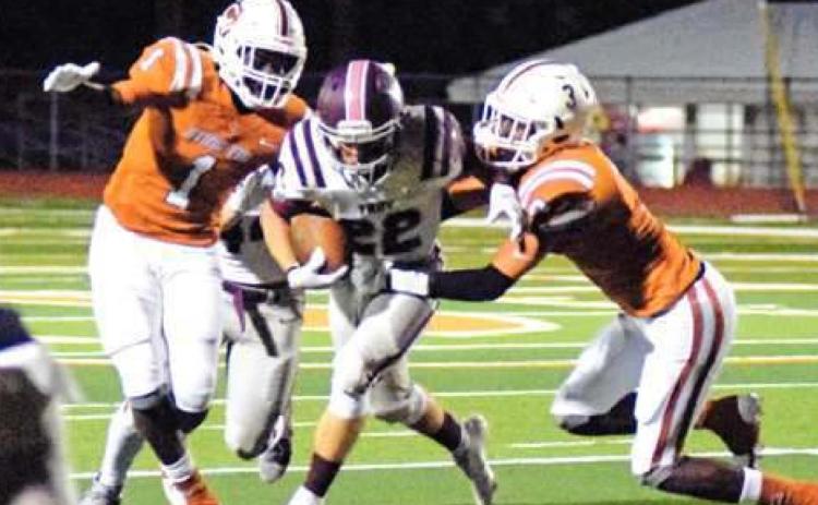 CALDWELL’S JAMAR HEWITT and Dontavien Johnson try to tackle Troy’s Brady Bearden during the Hornets’ home loss last Friday night.