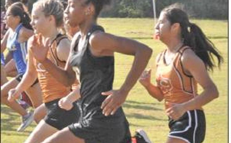 SOMERVILLE’S RAMAYA Carter runs with Caldwell’s Zoe Zwernemann and Jackie Gutierrez during the Caldwell Cross Country Invitational on Saturday morning.