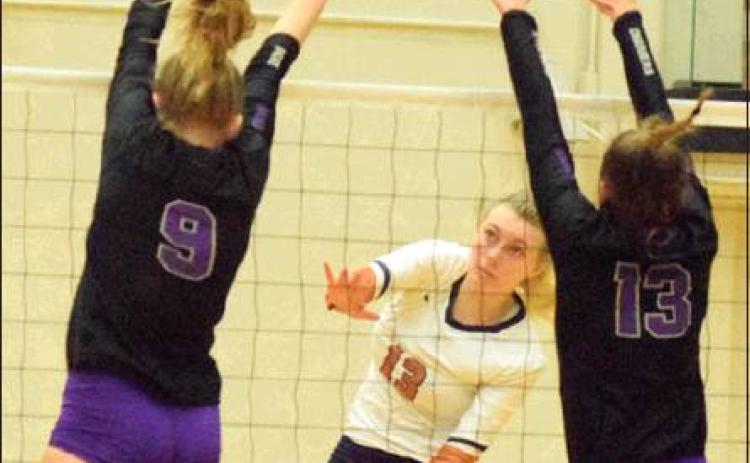 CALDWELL’S MARLEY MAURER hits the ball between the attempted blocks of Lamar Fulshear’s Skylar Voskuhl and Shelby Tally. Maurer MARLEY MAURER led the team in kills with 13. -- Tribune photo by Denise Hornaday