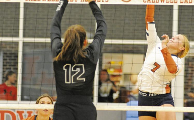 CALDWELL’S CAITLYN FAUST hits the ball over the net during the Lady Hornet’s loss to Sealy last Friday night in Hornet Gym.