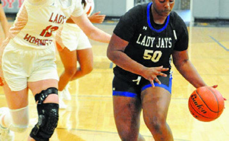 ROZARIA CARTER dribbles past Kaely Brown during last Tuesday’s Caldwell-Snook game at Hornet Gym. Tribune photo by Denise Squier
