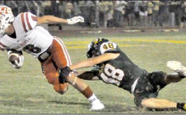 LOGAN KNESEK GETS away from this Lexington defender last Friday in Lexington. Caldwell’s defense excelled in a 20-8 victory, and the Hornets improved to 2-3. -- Tribune photo by Roy Sanders