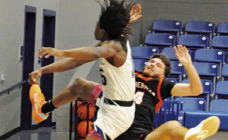 SOMERVILLE’S KASON ROHRBACH fights for ball against Mumford. Tribune photo by Denise Squier