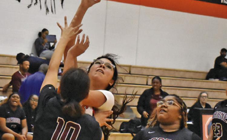 SOMERVILLE’S ARABELLA OROZCO takes a shot over Hearne’s Fernanda Luna while Hearne’s Katelyn Martinez watches. Tribune photo by Roy Sanders