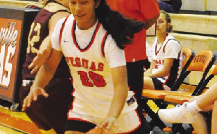 ANNETTE REYNA dribbles past a Milano player during the Lady Yeguas’ 51-20 loss to Milano last Friday. Reyna scored three points in the loss. Tribune photo by Denise Squier