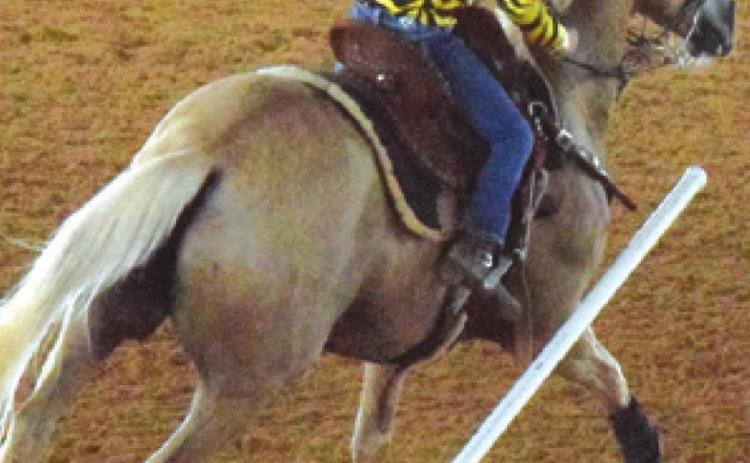 THIS RIDER KNOCKS over a pole during the Burleson County Saddle Club’s Youth Rodeo on Saturday. -- Tribune photo by Denise Squier