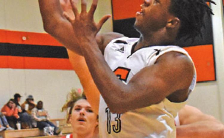 D.J. BRYANT SHOOTS the ball during the Somerville-Bellville game last Tuesday night. Also pictured is Johnny Legg.