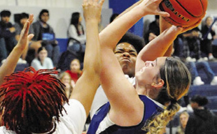 ALEXIS MACIK is triple-teamed by Hearne during the Snook Lady Jay Basketball Tournament. -- Tribune photo by Denise Squier
