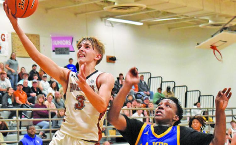 DYLAN CHAPMAN OF Caldwell takes a layup shot against LaVega in the Dec. 5 game in Caldwell. -- Tribune photo by Roy Sanders